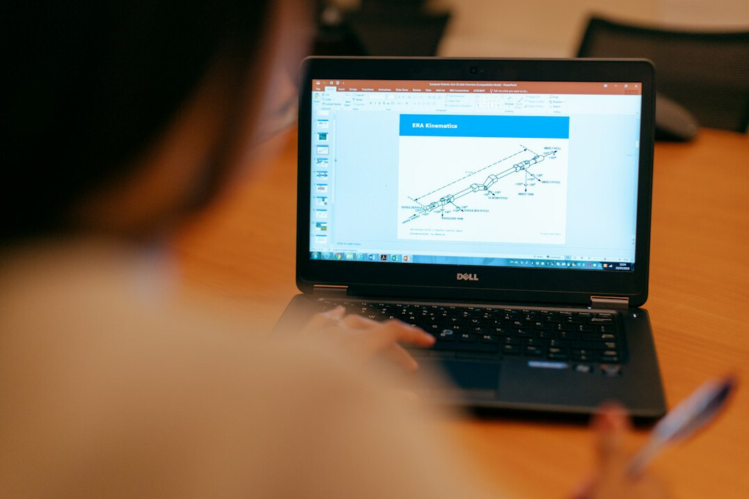 japanese student coding on laptop