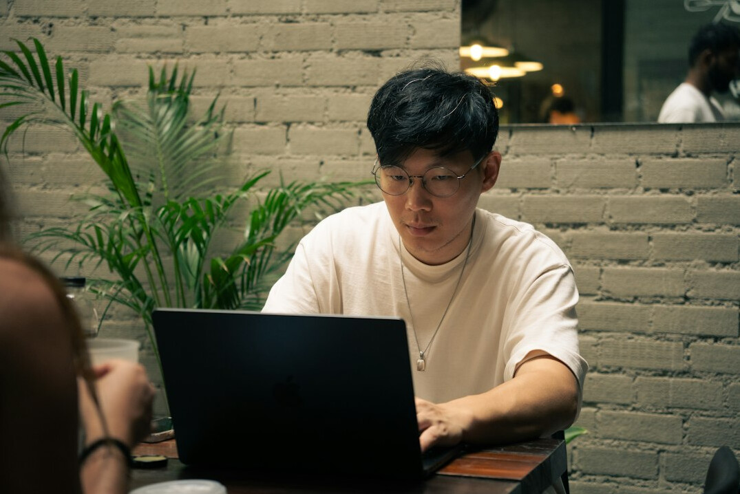 japanese student coding on laptop