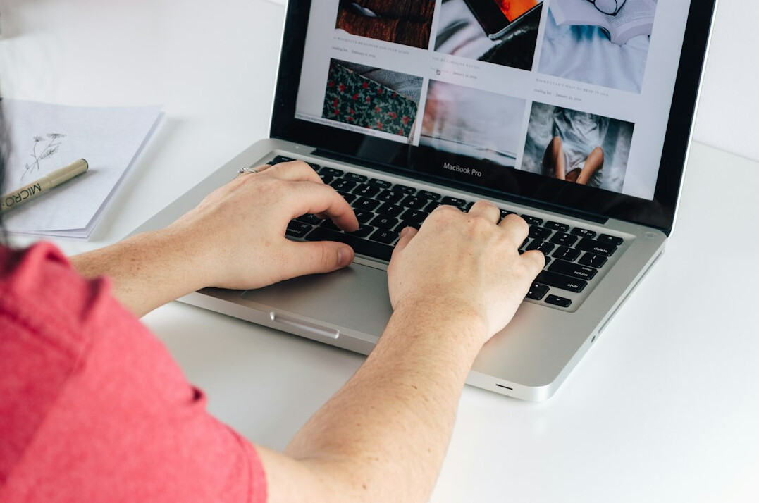 person building website on laptop