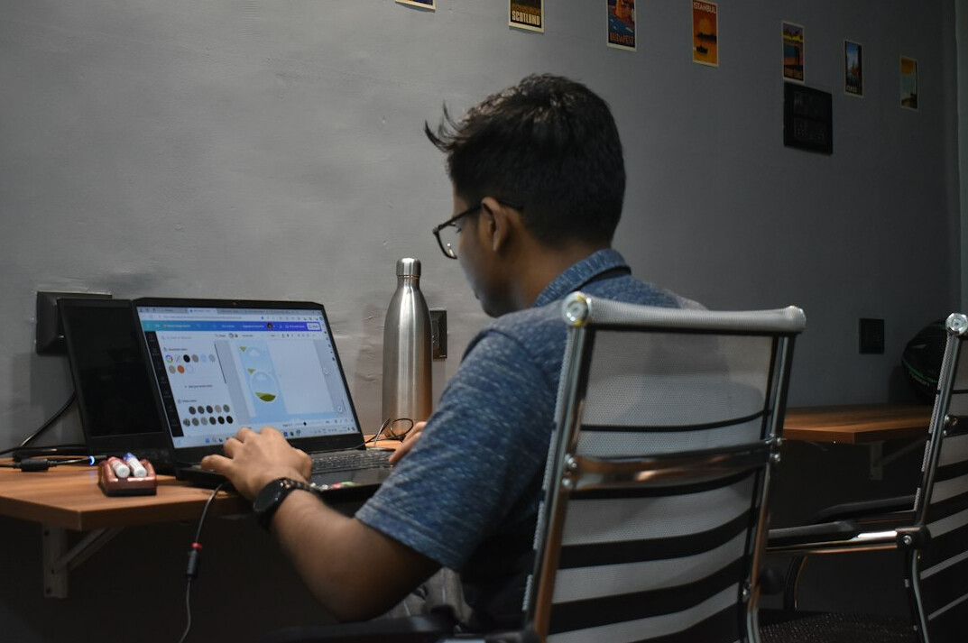japanese student coding on laptop